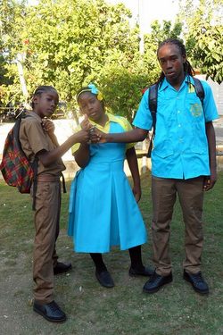 Makiva (center) her big brother Zion (right), and a fellow student ready for school.