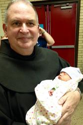Br. Andre Lemay, OFM, with a recent arrival.