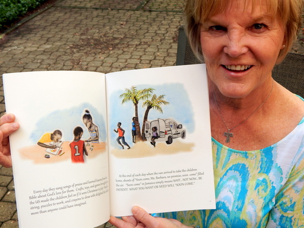 Author Barb Coyle holds her book, "In the Land of "Soon Come" illustrated by 14-year-old Taylor Kling.