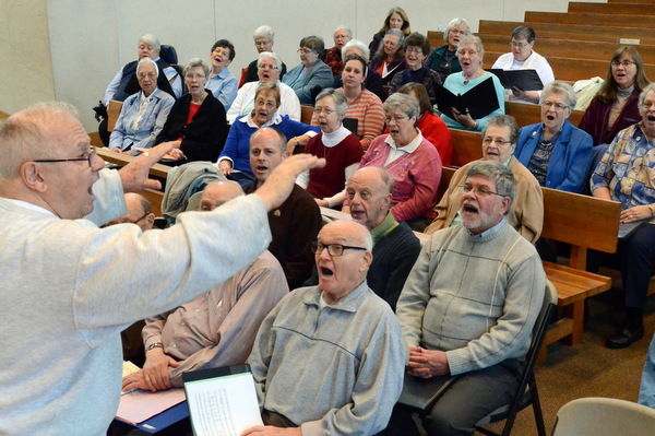 Fr. Fred Link, OFM, leads the choir practice for the 'Wake Up the World' concert celebrating consecrated life.