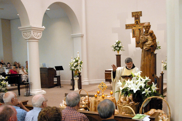 Fr. Jeff Scheeler, OFM, blesses the St. Anthony Bread at the National Shrine of St. Anthony of Padua in Cincinnati.