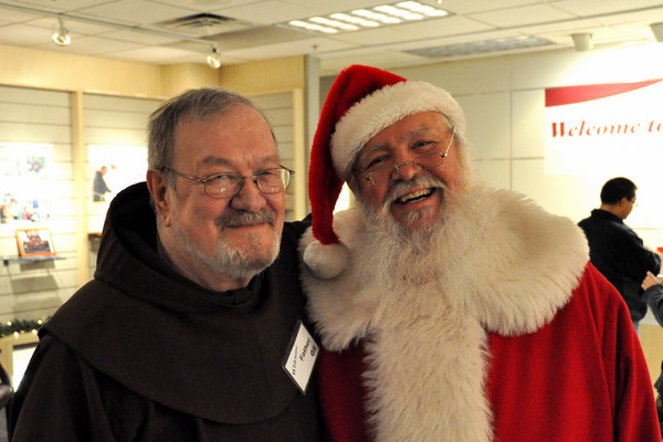 Fr. Gil Wohler, OFM, with Santa Claus at Northgate Mall during 'Advent with the Franciscans' 