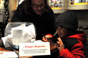 A young visitor writes a prayer request