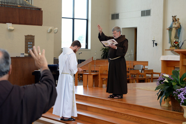 Fr. Richard Goodin, OFM, receives a blessing from Provincial Minister Fr. Jeff Scheeler, OFM, and the congregation