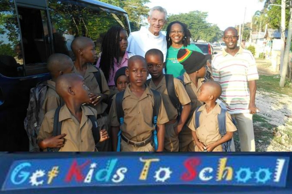 Fr. Jim Bok, OFM, Joan Cooney (Ms. Joans)  and her brother James with students from the 'Get Kids To School' program as they board 'Josey' the van that will take them to school.