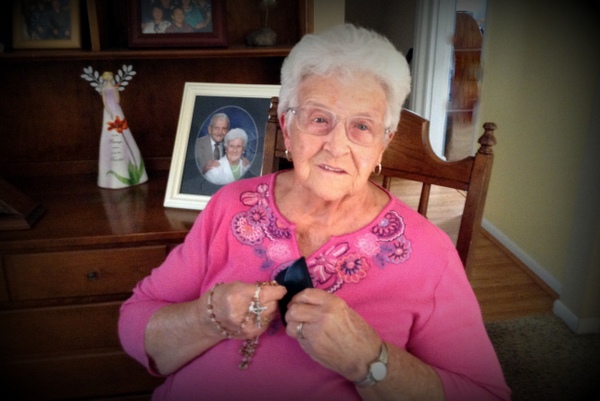 Marian with her special rosary made from the roses from her husband Don's coffin.