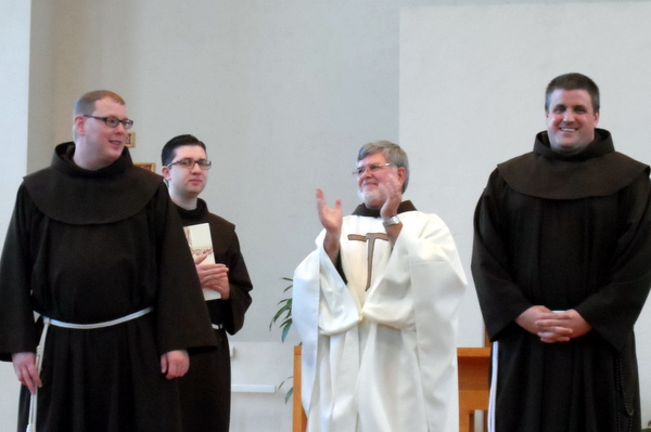Br. Michael Charron, OFM, (left) and Br. Colin King, OFM (right) receive applauds from Provincial Minister Fr. Jeff Scheeler, OFM, and Br. Adam Farkas, OFM